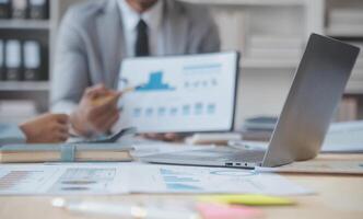 Finance manager meeting discussing company growth project success financial statistics, professional investor working start up project for strategy plan with document, laptop and digital tablet. photo