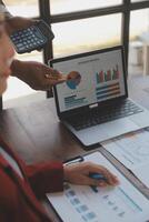 Finance manager meeting discussing company growth project success financial statistics, professional investor working start up project for strategy plan with document, laptop and digital tablet. photo