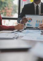 Finance manager meeting discussing company growth project success financial statistics, professional investor working start up project for strategy plan with document, laptop and digital tablet. photo