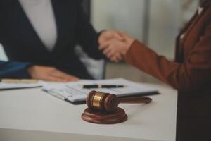 Lawyer, legal advisor, businessman brainstorming information on agreement details Business contracts in legal processing books for accuracy in contract documents. joint financial investment. photo