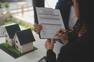 Business Signing a Contract Buy - sell house, insurance agent analyzing about home investment loan Real Estate concept. photo