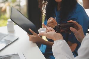 biochemical research scientist team working with microscope for coronavirus vaccine development in pharmaceutical research labolatory, selective focus photo