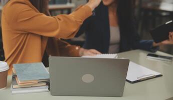 Asian businesswoman working on laptop computer Look for job online, freelance looking and typing on notebook on table, lifestyle of woman studying online photo