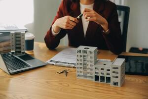 Real estate agent and customer discussing for contract to buy, get insurance or loan real estate or property. photo