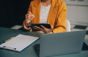 Portrait of a successful business woman using digital tablet photo