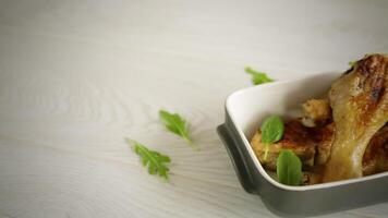 grilled chicken legs fried with spices and herbs in a ceramic bowl video