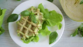 vegetable waffles cooked with herbs in a plate on a wooden table video