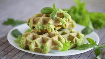 vegetable waffles cooked with herbs in a plate on a wooden table video