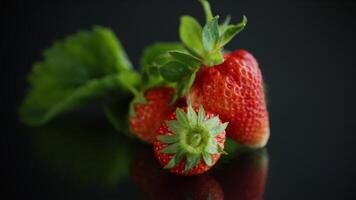 Ripe juicy red strawberry isolated on black background video