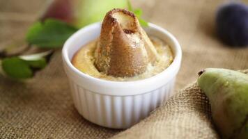 pear baked in curd dough in a small ceramic form, on burlap video