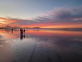 puesta de sol en famara playa en lanzarote isla foto