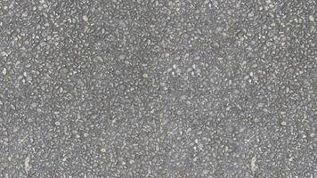 AI generated A uniform gray asphalt texture made up of small stones and pebbles in varying shades of gray like road texture background photo