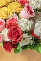 Beautiful bouquet of artificial multicolored flowers in box, close-up, selective focus photo