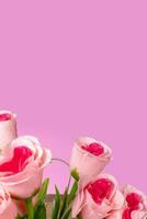 Bouquet of pink roses on pink background with copy space for your text photo