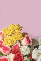 Bouquet of colorful roses on pink background with copy space. photo