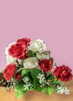 Bouquet of red and white roses on a pink background with copy space for your text. photo