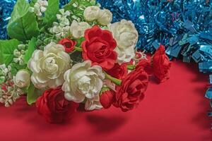 Bouquet of white and red roses on a red background photo