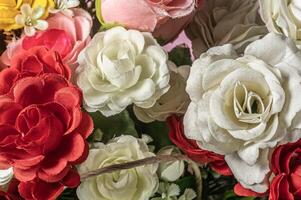 Beautiful artificial multicolored flowers as background, closeup. photo