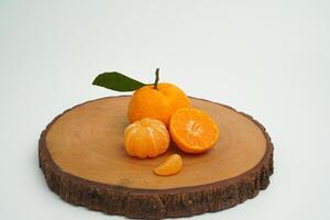 Group of orange fruit consists of whole, piece and half orange on wood isolated on white background photo