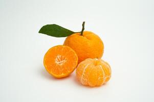 Group of orange fruit consists of whole, piece and half orange isolated on white background photo