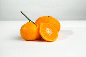 Group of oranges cut in half and pieces isolated on white background with shadow. Clipping path. Orange for commercial use product photo