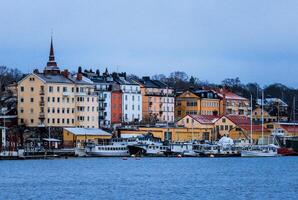 Bustling Harbor With Numerous Boats Next to Tall Buildings in Sweden photo