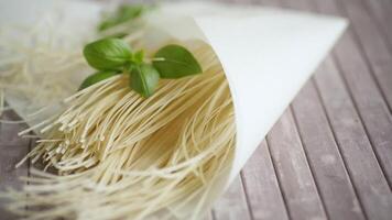 homemade thin dried egg noodles in paper bag with basil video