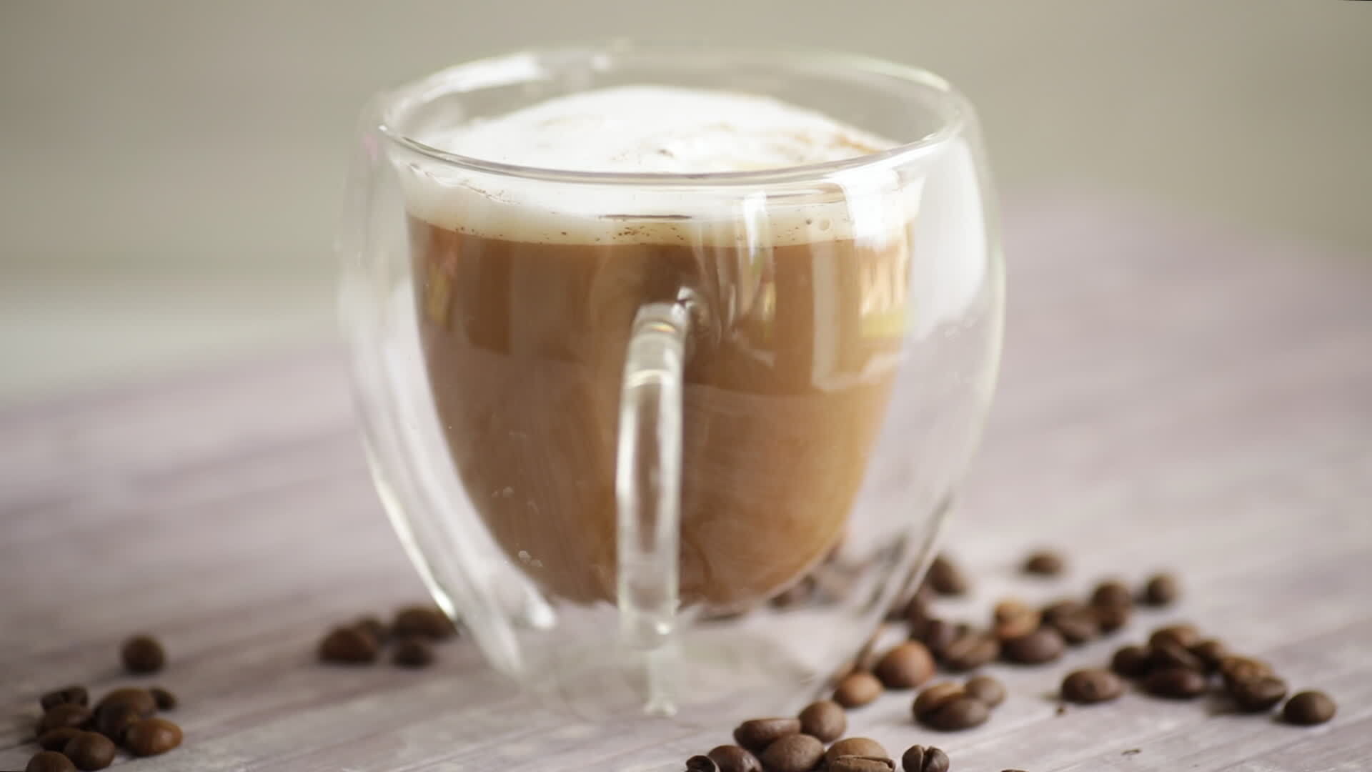 A cup of hot coffee with milk with coffee beans 39031907 Stock Video at