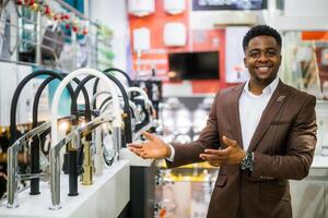 Portrait of salesperson in bathroom store. Happy man works in bath store. Sales occupation. photo