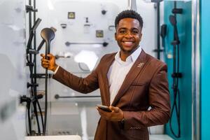 Portrait of buyer in bathroom store. Man is choosing bathtub for his apartment. photo