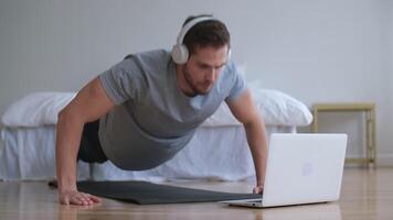 Family fitness at home, Father coach, Sports kid, Fun gymnastics. Man using laptop during online sports training video
