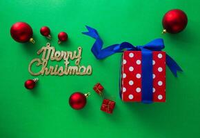 Gift boxes and Christmas decorations on green background photo