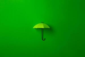 Green umbrella isolated on purple background. photo