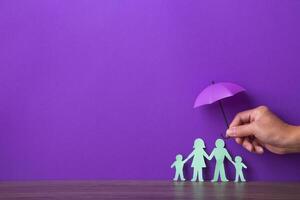 Hand holding a small purple umbrella. photo