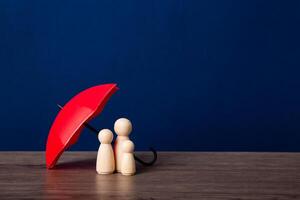 Umbrella and wooden doll figures. photo