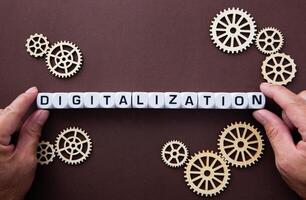 Wooden gears with word Digitalization. Digitalization Concept photo