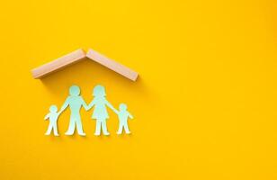 Paper cut out of family .Life insurance concept. photo