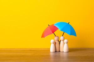 Umbrella and wooden doll figures. photo