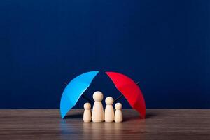 Umbrella and wooden doll figures. photo