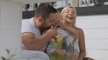 Happy Father and mother are playing with their little beautiful son while having a good mood. Portrait video