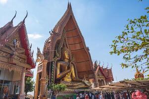 kanchanaburi.thailand-16.1.2022 unacquainted people at Wat Tham Suea Tiger Cave Temple kanchanaburi.An 18-meter-tall Buddha built in 1973 is the focus of this well-known temple on a hilltop. photo