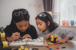 Asian students enjoy Machine Learning Robot arms Control robots in technology class, stem education robot arms for digital automation software for artificial intelligence AI. STEM education concept. photo