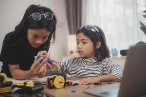 Asian students enjoy Machine Learning Robot arms Control robots in technology class, stem education robot arms for digital automation software for artificial intelligence AI. STEM education concept. photo