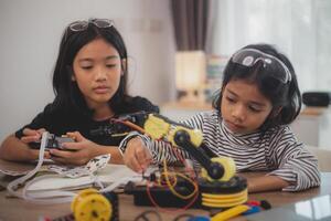 Asian students enjoy Machine Learning Robot arms Control robots in technology class, stem education robot arms for digital automation software for artificial intelligence AI. STEM education concept. photo