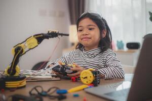 Asian students enjoy Machine Learning Robot arms Control robots in technology class, stem education robot arms for digital automation software for artificial intelligence AI. STEM education concept. photo