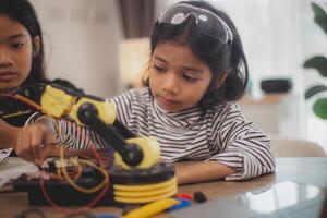 Asian students enjoy Machine Learning Robot arms Control robots in technology class, stem education robot arms for digital automation software for artificial intelligence AI. STEM education concept. photo