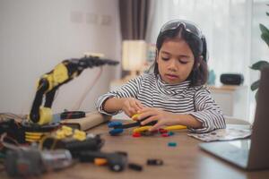 Asian students enjoy Machine Learning Robot arms Control robots in technology class, stem education robot arms for digital automation software for artificial intelligence AI. STEM education concept. photo