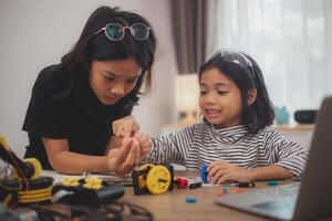 Asian students enjoy Machine Learning Robot arms Control robots in technology class, stem education robot arms for digital automation software for artificial intelligence AI. STEM education concept. photo