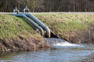 pumping station on a river with dike photo