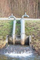 pumping station on a river with dike photo